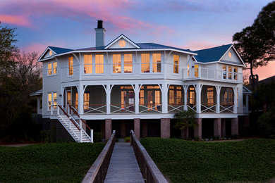 Inspiration for a large coastal multicolored two-story house exterior remodel in Charleston with a metal roof