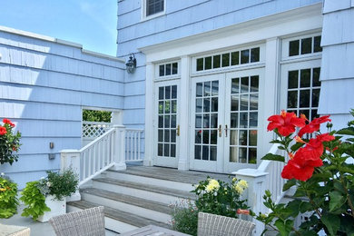 Example of a large beach style blue two-story wood exterior home design in New York