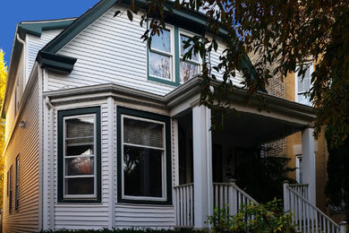 Inspiration for a transitional white two-story vinyl gable roof remodel in Chicago