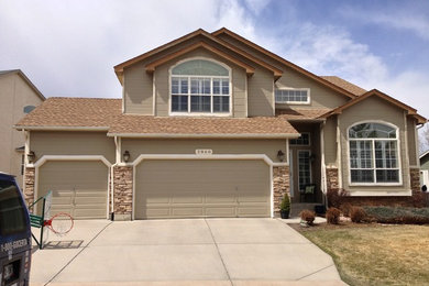 Inspiration for a large timeless beige two-story mixed siding gable roof remodel in Denver