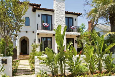 Inspiration for a mid-sized mediterranean white two-story adobe house exterior remodel in San Diego with a hip roof and a tile roof