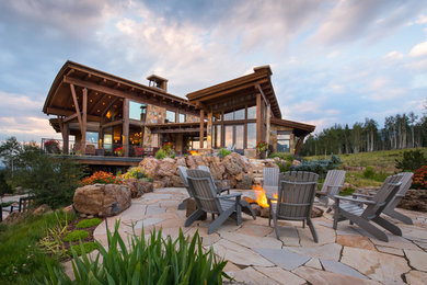 Photo of an expansive and brown traditional two floor detached house in Denver with stone cladding, a lean-to roof and a metal roof.