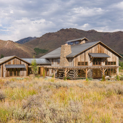 Inspiration for a rustic two-story wood gable roof remodel in Other