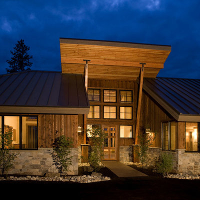 Mid-sized rustic one-story wood exterior home idea in Seattle with a shed roof