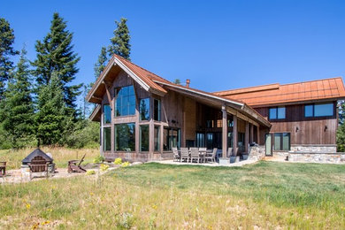 Mountain style brown two-story mixed siding house exterior photo in Seattle with a metal roof