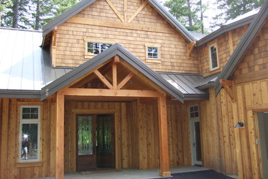 Diseño de fachada de casa marrón de estilo americano grande de dos plantas con revestimiento de madera, tejado a dos aguas y tejado de metal