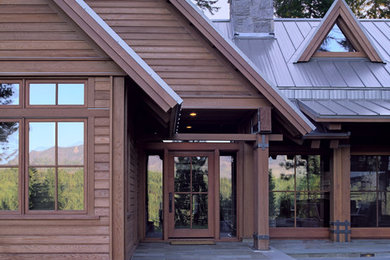Inspiration for a mid-sized rustic brown two-story wood exterior home remodel in Seattle with a metal roof