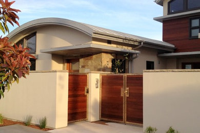 Foto della facciata di una casa grande beige contemporanea con rivestimento in cemento