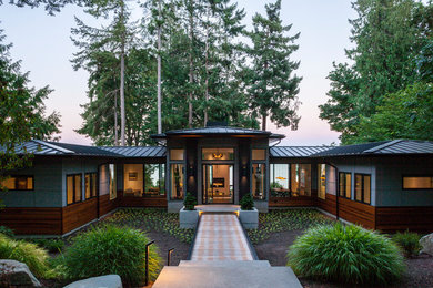 Example of a trendy gray one-story mixed siding house exterior design in Seattle with a hip roof and a metal roof