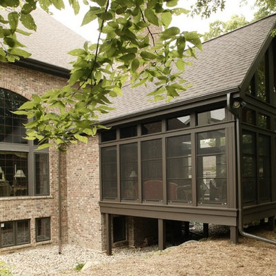 Inspiration for a large timeless brown one-story mixed siding exterior home remodel in Other with a shingle roof
