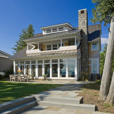 Large beach style two-story wood house exterior photo in Burlington