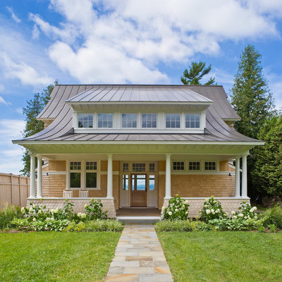 Inspiration for a large coastal two-story wood house exterior remodel in Burlington with a metal roof