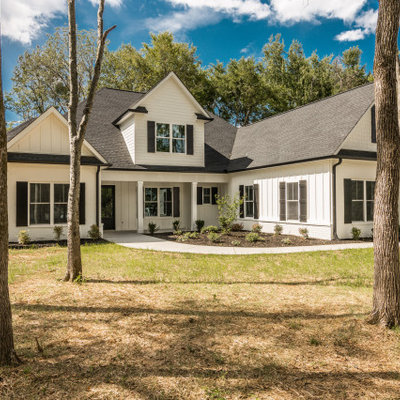 Large cottage white two-story mixed siding exterior home photo in Nashville with a shingle roof