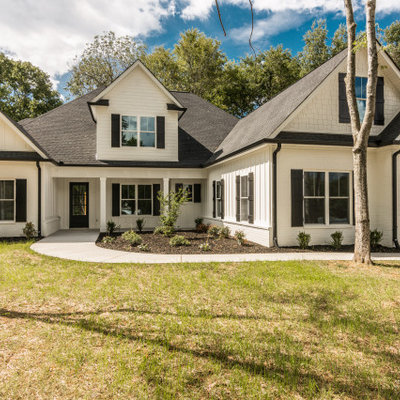 Inspiration for a large cottage white two-story mixed siding exterior home remodel in Nashville with a shingle roof
