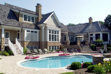 Inspiration for a large timeless beige two-story mixed siding exterior home remodel in Chicago with a shingle roof