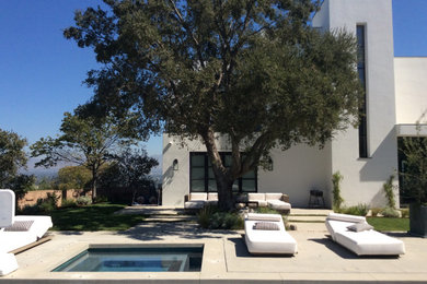 Inspiration for a contemporary white two-story stucco exterior home remodel in Los Angeles