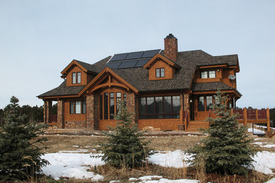 Example of a large arts and crafts brown two-story wood exterior home design in Denver