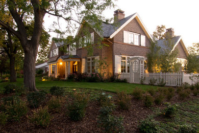 Example of a classic two-story brick exterior home design in Denver