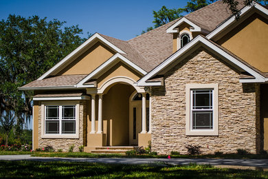 Large transitional multicolored two-story mixed siding exterior home photo in Jacksonville with a shingle roof