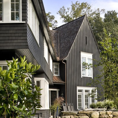 Large traditional black two-story wood, board and batten and shingle gable roof idea in New York