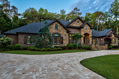 Inspiration for a large timeless beige two-story stone exterior home remodel in Atlanta