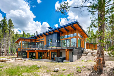 Inspiration for a large modern brown two-story wood exterior home remodel in Denver