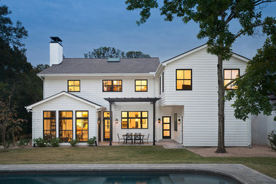 Large transitional white two-story vinyl exterior home photo in Austin with a shingle roof