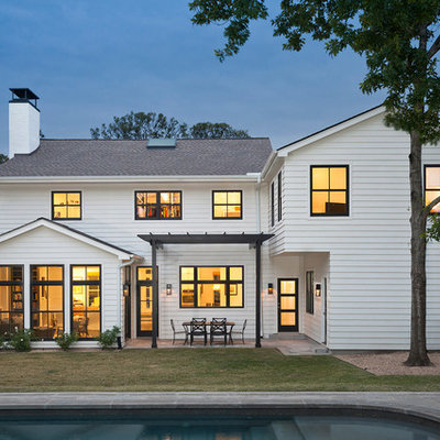 Large transitional white two-story vinyl exterior home photo in Austin with a shingle roof