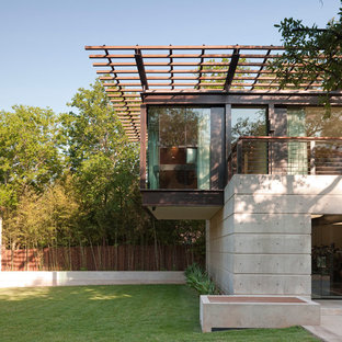 Medium sized and gey modern two floor concrete detached house in Austin with a flat roof.