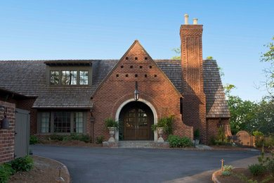 Exemple d'une grande façade de maison multicolore chic en brique à un étage avec un toit à deux pans et un toit en shingle.