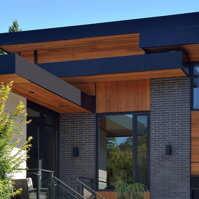Large contemporary gray two-story mixed siding flat roof idea in Toronto
