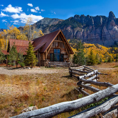 Inspiration for a large rustic brown one-story mixed siding exterior home remodel in Denver with a metal roof