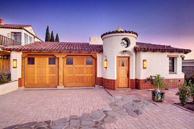 Inspiration for a mediterranean white one-story exterior home remodel in Orange County