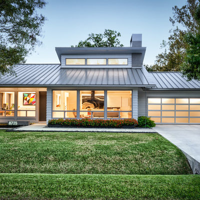 1960s gray one-story concrete fiberboard house exterior photo in Houston with a hip roof and a metal roof