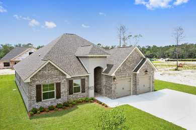 Example of a mid-sized classic one-story house exterior design in Other with a shingle roof