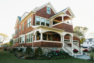 Large coastal brown two-story wood gable roof idea in Providence
