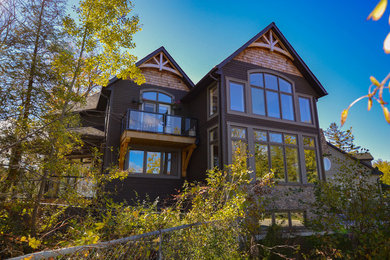 Example of an arts and crafts gray two-story wood exterior home design in Toronto with a shingle roof
