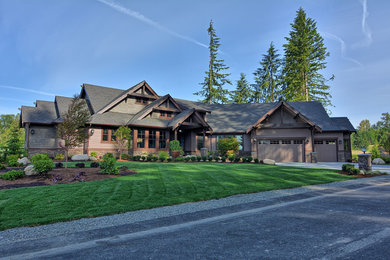 Huge craftsman brown two-story mixed siding house exterior idea in Seattle with a hip roof and a shingle roof