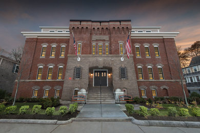 Design ideas for a traditional brick house exterior in Boston with three floors.