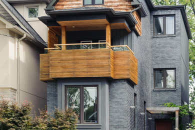 Inspiration for a modern gray three-story exterior home remodel in Toronto