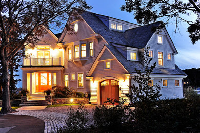 Example of a beach style gray three-story wood house exterior design in Boston with a gambrel roof and a shingle roof