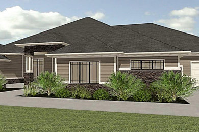 This is an example of a large and beige traditional two floor detached house in Omaha with mixed cladding, a hip roof and a shingle roof.