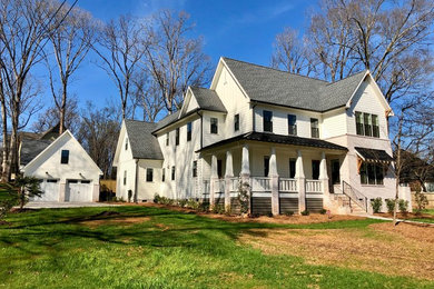 Example of a huge farmhouse white two-story concrete fiberboard house exterior design in Charlotte with a shingle roof