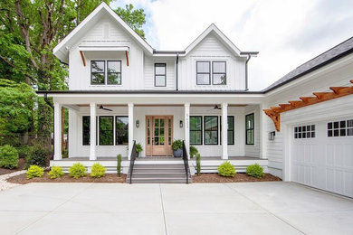 Example of a large country white three-story wood exterior home design in Charlotte with a shingle roof