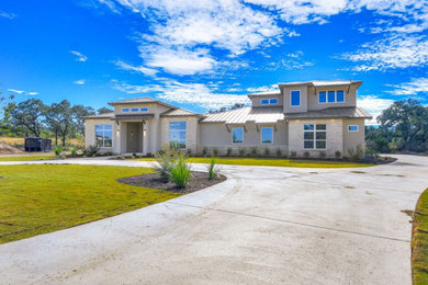 Example of a large trendy gray two-story stucco exterior home design in Other