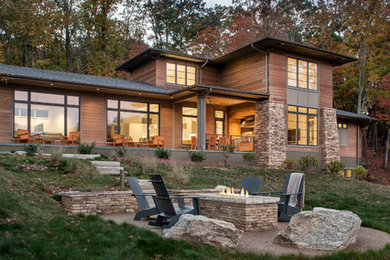 Inspiration for a large modern brown three-story wood exterior home remodel in Other with a shingle roof