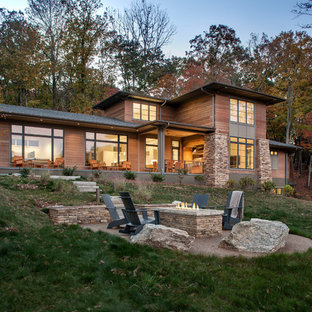 Inspiration for a large modern brown three-story wood exterior home remodel in Other with a shingle roof