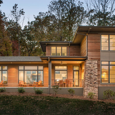 Example of a large minimalist brown three-story wood exterior home design in Other with a shingle roof