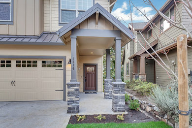 Example of a mid-sized transitional beige two-story concrete fiberboard gable roof design in Portland