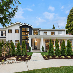 Large country white two-story house exterior idea in Seattle